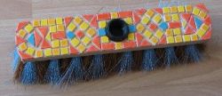 Covering the broom with the mosaic tiles